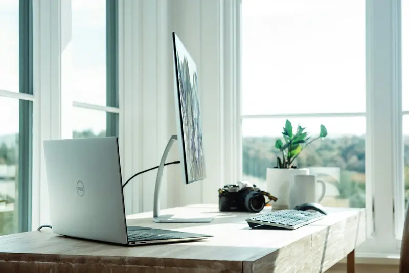 Business laptop and monitor on an office desk