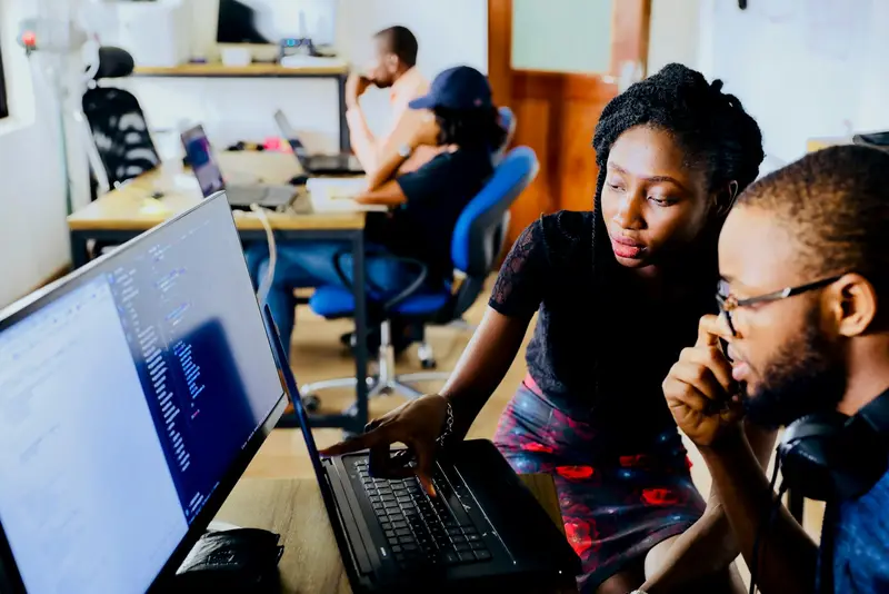 IconLogic team members reviewing a project at a workstation